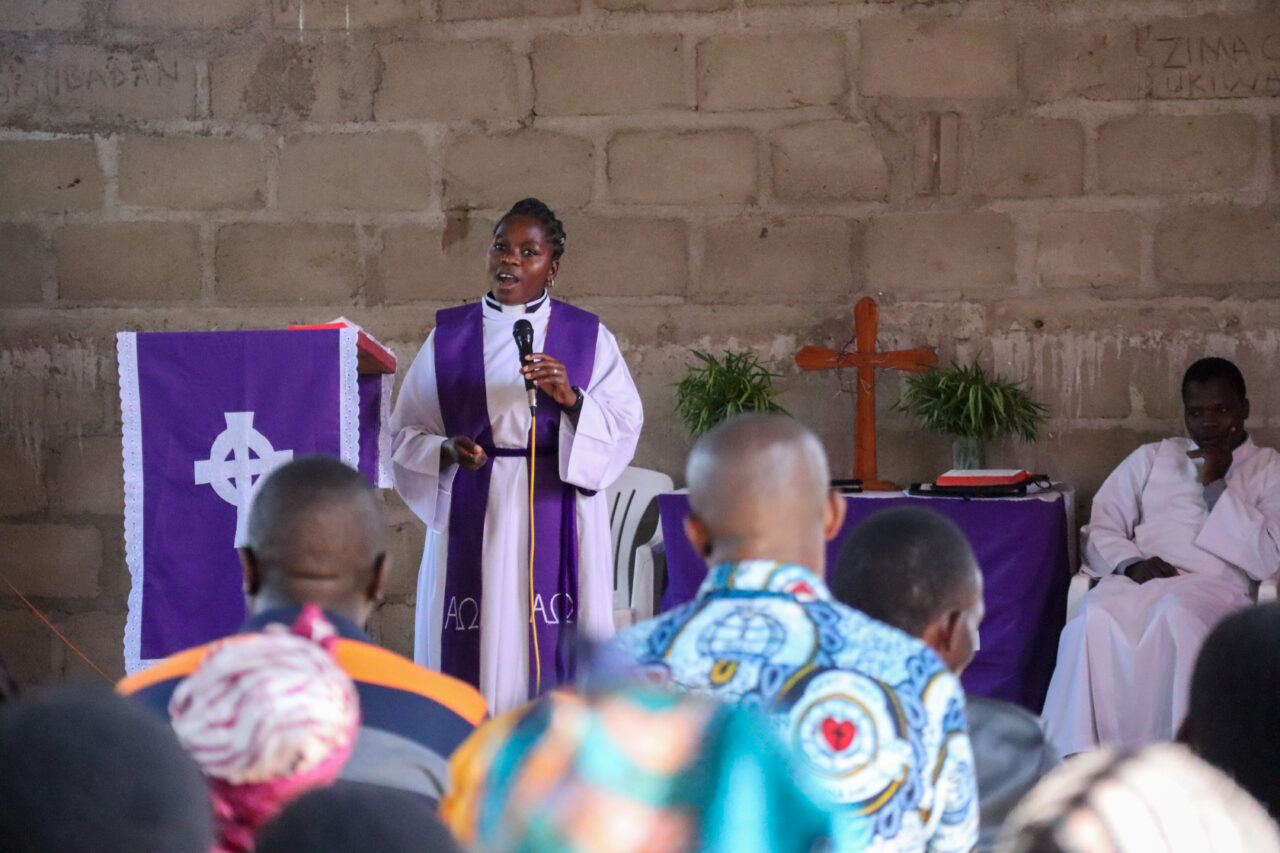 Pastor Peweni Kikoti preaching.